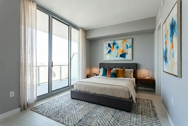 a bedroom with a large bed and a window