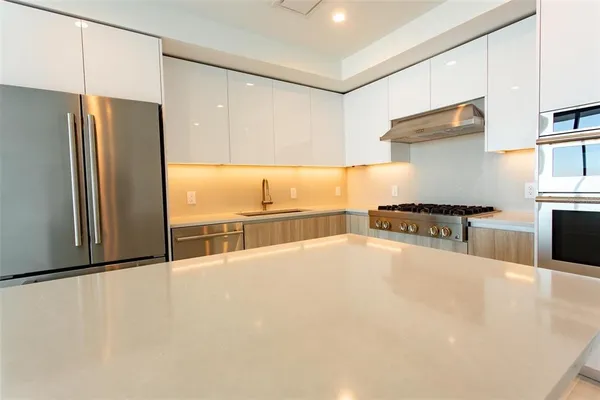 a kitchen with stainless steel appliances a refrigerator and a stove
