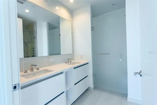 a bathroom with a double vanity sink and mirror