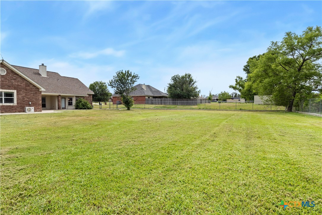 283 County Road 4710 Kempner, TX 76539 - Photo 47 of 47 a view of a large pool with lawn chairs under an umbrella