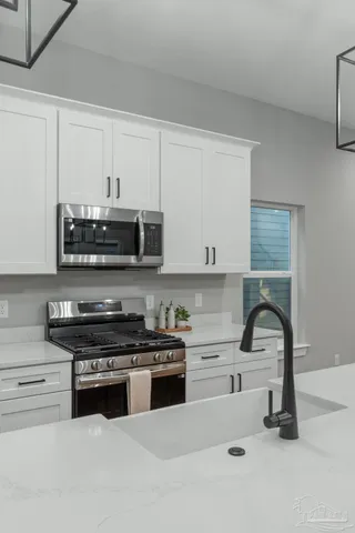 a kitchen with granite countertop a stove and a sink