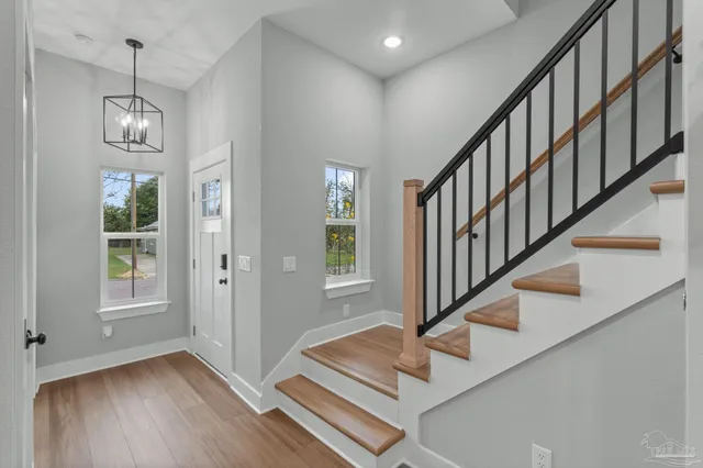 a view of entryway and hall with wooden floor