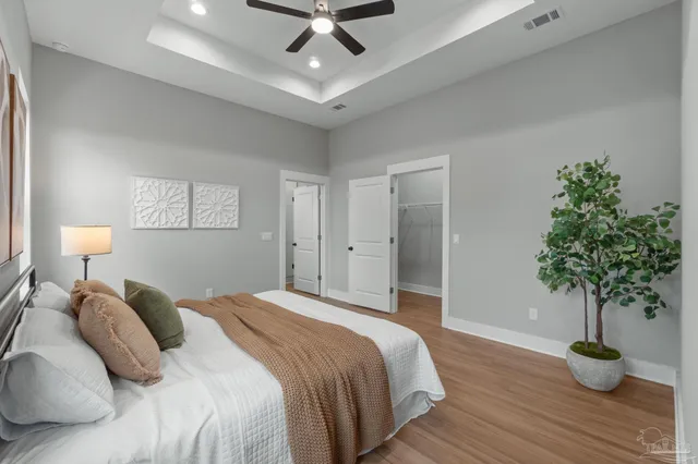 a bedroom with a bed and a potted plant