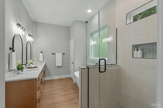 a bathroom with a granite countertop sink a toilet and with mirror