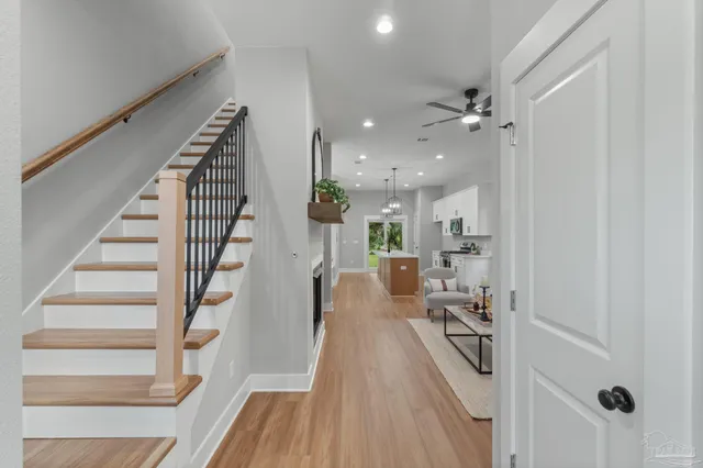 a view of a living room with a sink and wooden floor