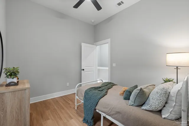 a bedroom with a bed and a lamp