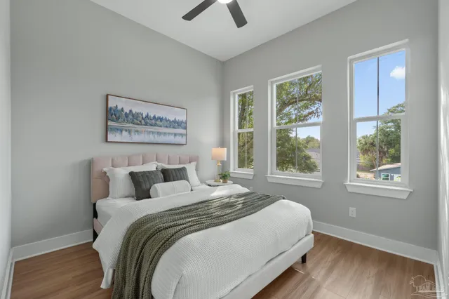 a bedroom with a large bed and a window