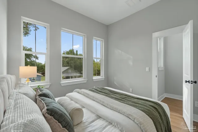 a bedroom with a bed and a window