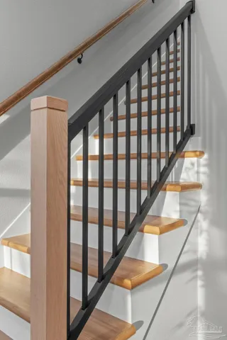 a view of staircase with lots of white walls and a window