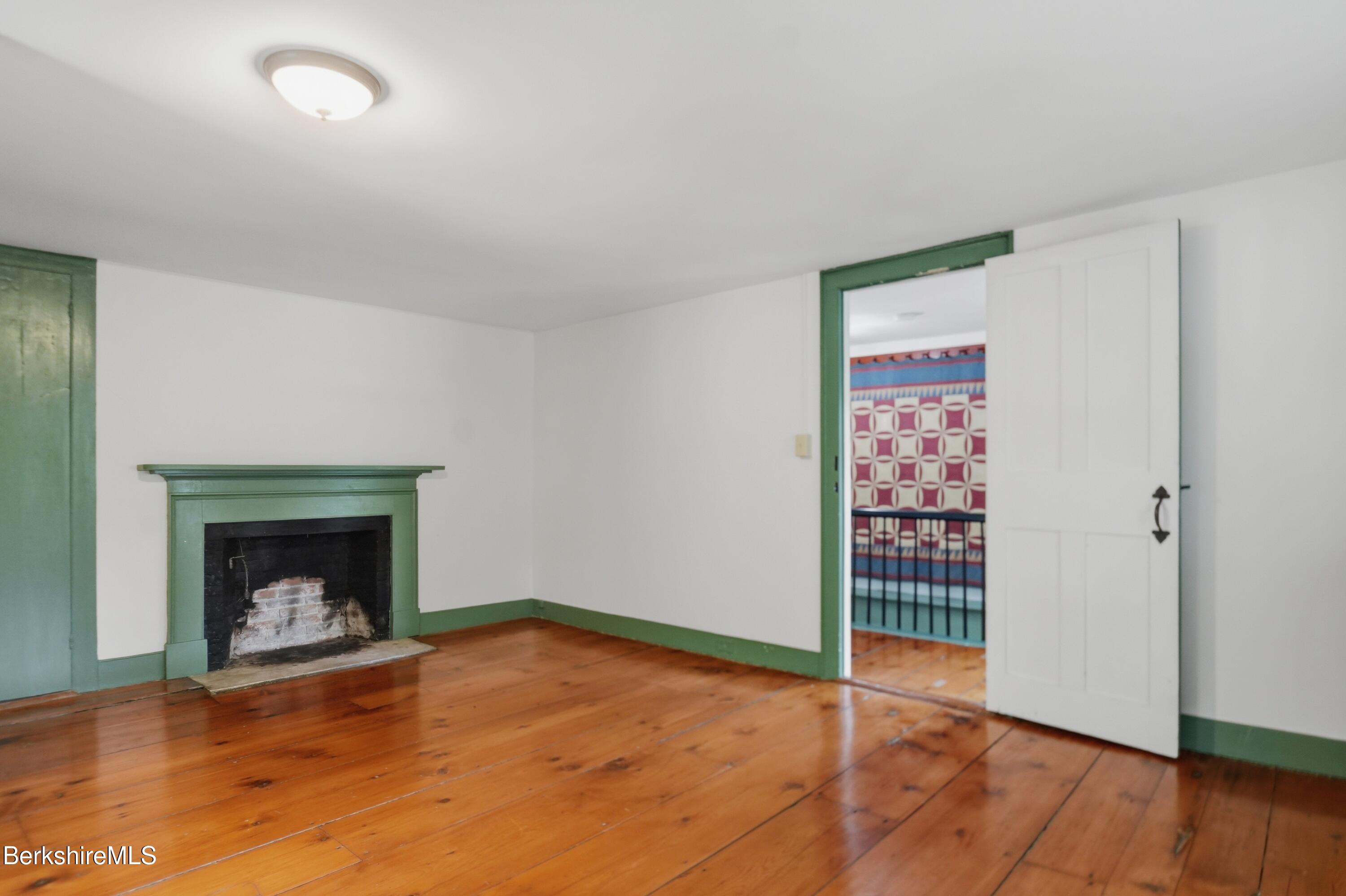 4 Stockbridge Road West Stockbridge, MA 01266 - Photo 50 of 94 a view of an empty room with wooden floor and a fireplace