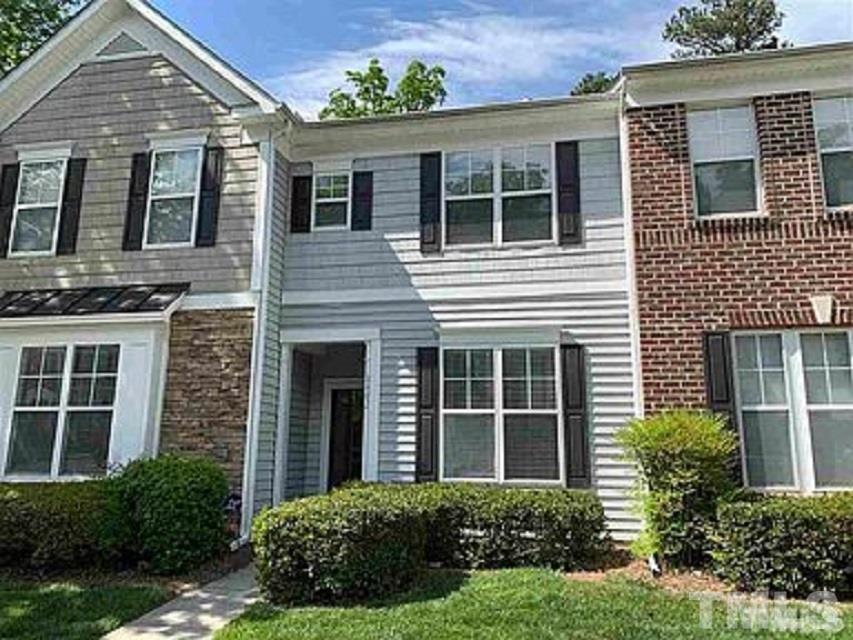 8482 Central Drive Raleigh, NC 27613 - Photo 1 of 6 a view of a house with brick walls and a yard with potted plants