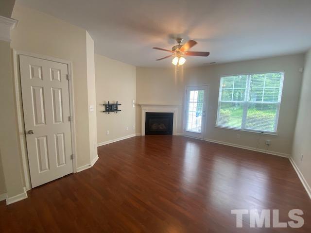 8482 Central Drive Raleigh, NC 27613 - Photo 2 of 6 an empty room with wooden floor fan and windows