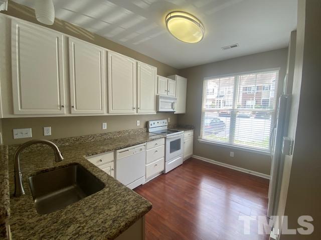 8482 Central Drive Raleigh, NC 27613 - Photo 3 of 6 a kitchen with granite countertop a stove sink and cabinets