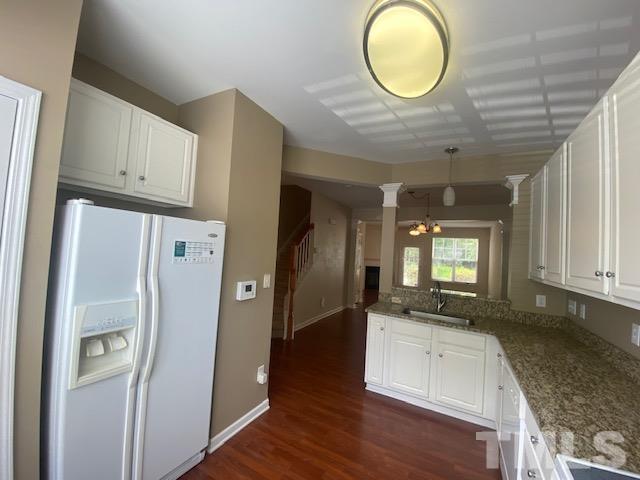 8482 Central Drive Raleigh, NC 27613 - Photo 4 of 6 a view of a kitchen with a sink and a refrigerator