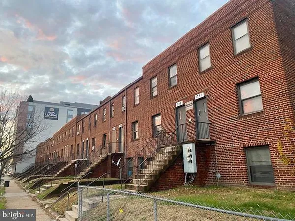 a large building with a yard in front of it