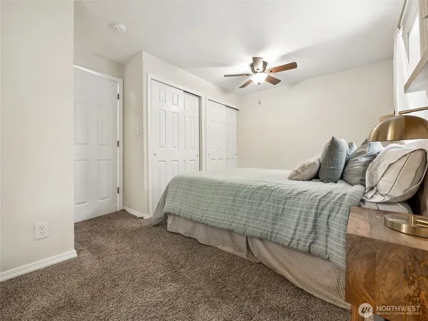 a bedroom with a bed and a ceiling fan