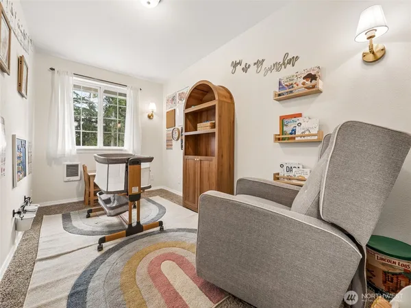 a view of a workspace with furniture and a window