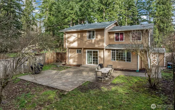 a view of an house with backyard space and balcony