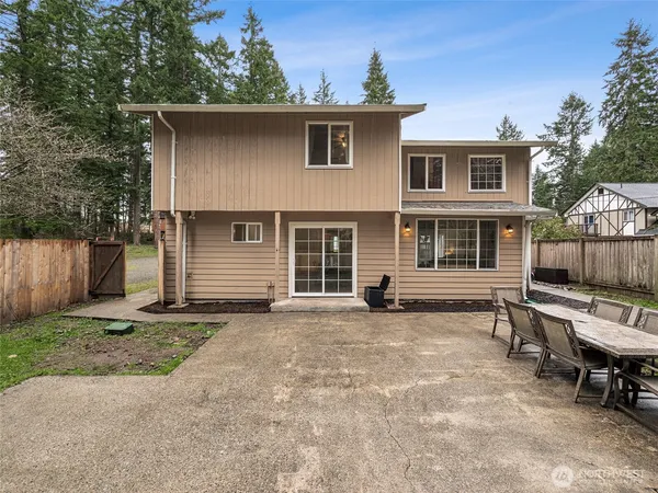 a view of a house with a yard and wooden fence