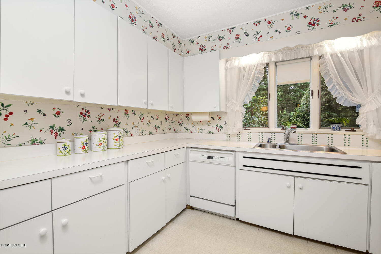 28 Pheasant Lane Greenwich, CT 06830 - Photo 17 of 49 a kitchen with granite countertop white cabinets a sink and dishwasher next to a window