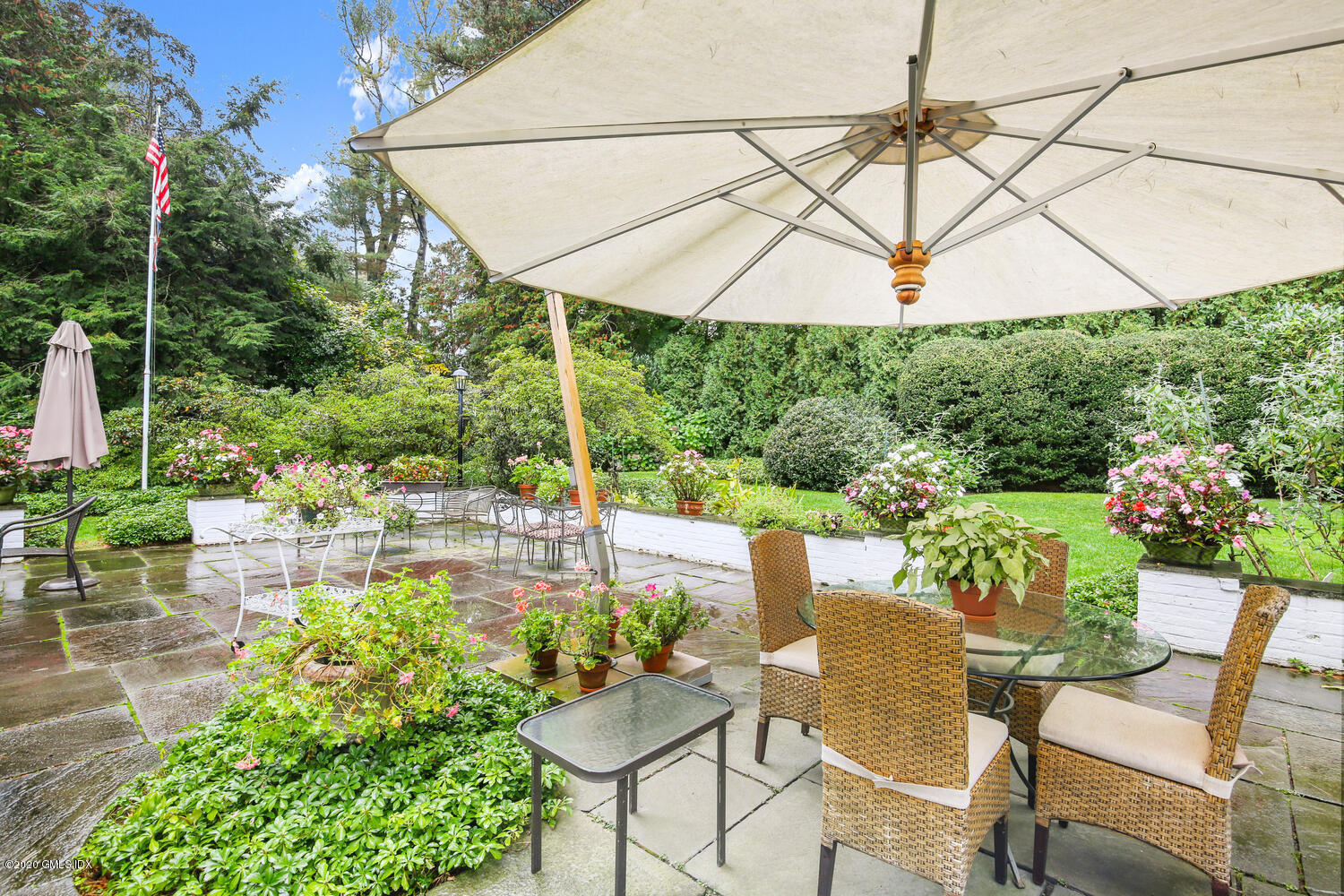 28 Pheasant Lane Greenwich, CT 06830 - Photo 37 of 49 a patio with a patio table and chairs