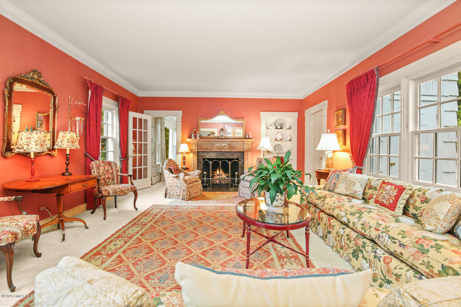 28 Pheasant Lane Greenwich, CT 06830 - Photo 6 of 49 a living room with furniture a fireplace and large windows