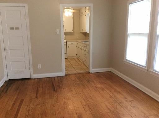 3405 24th Street Lubbock, TX 79410 - Photo 3 of 11 an empty room with wooden floor and windows