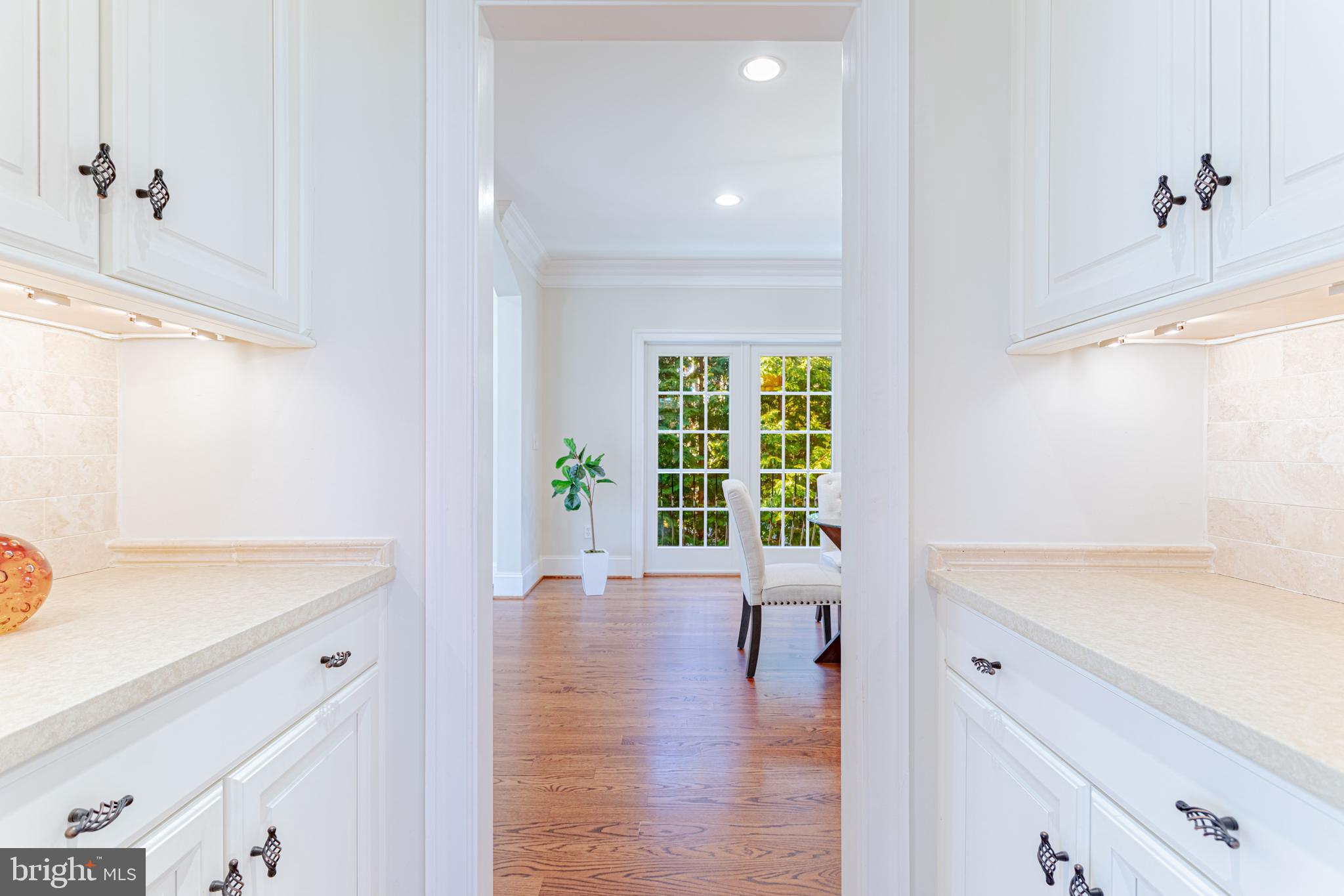 1206 Summit Road McLean, VA 22101 - Photo 15 of 45 a hallway with a sink and a large mirror with wooden floor