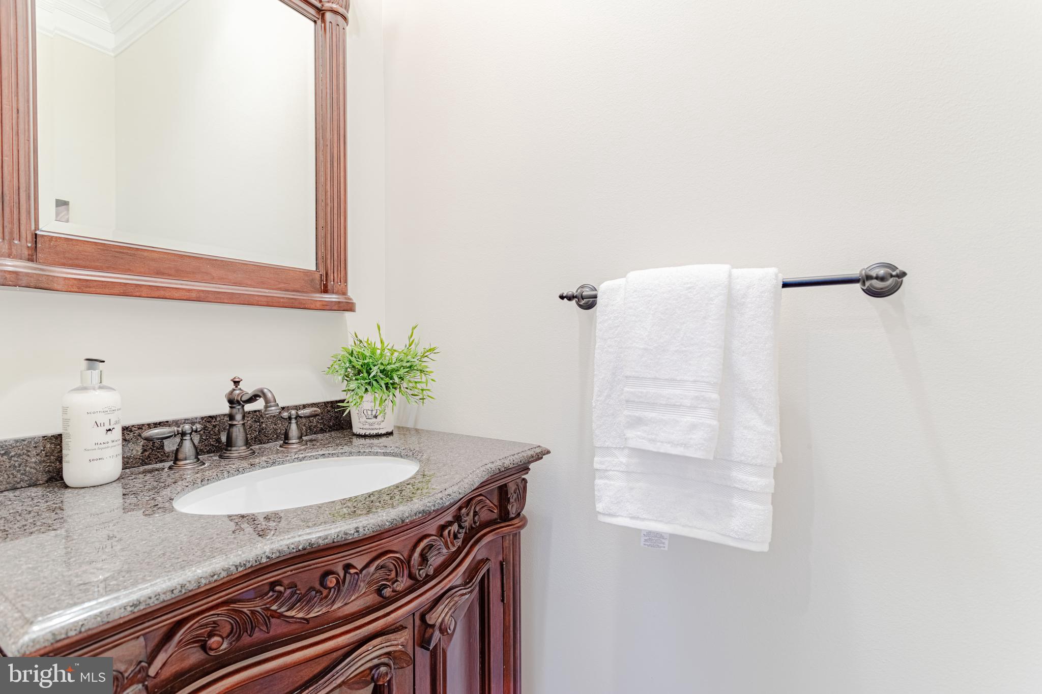 1206 Summit Road McLean, VA 22101 - Photo 20 of 45 a bathroom with a granite countertop sink and a mirror