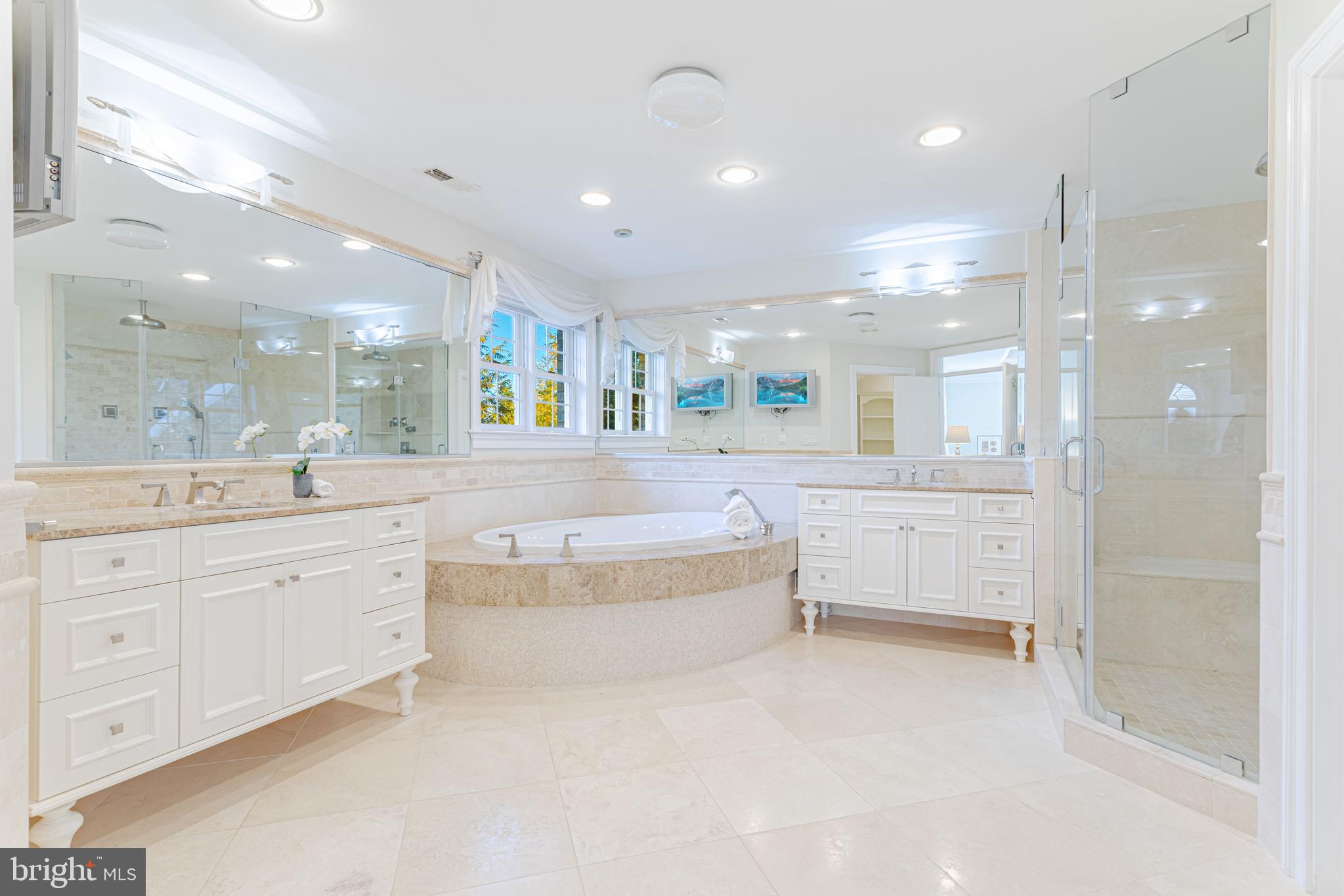 1206 Summit Road McLean, VA 22101 - Photo 25 of 45 a large bathroom with a large mirror vanity and shower