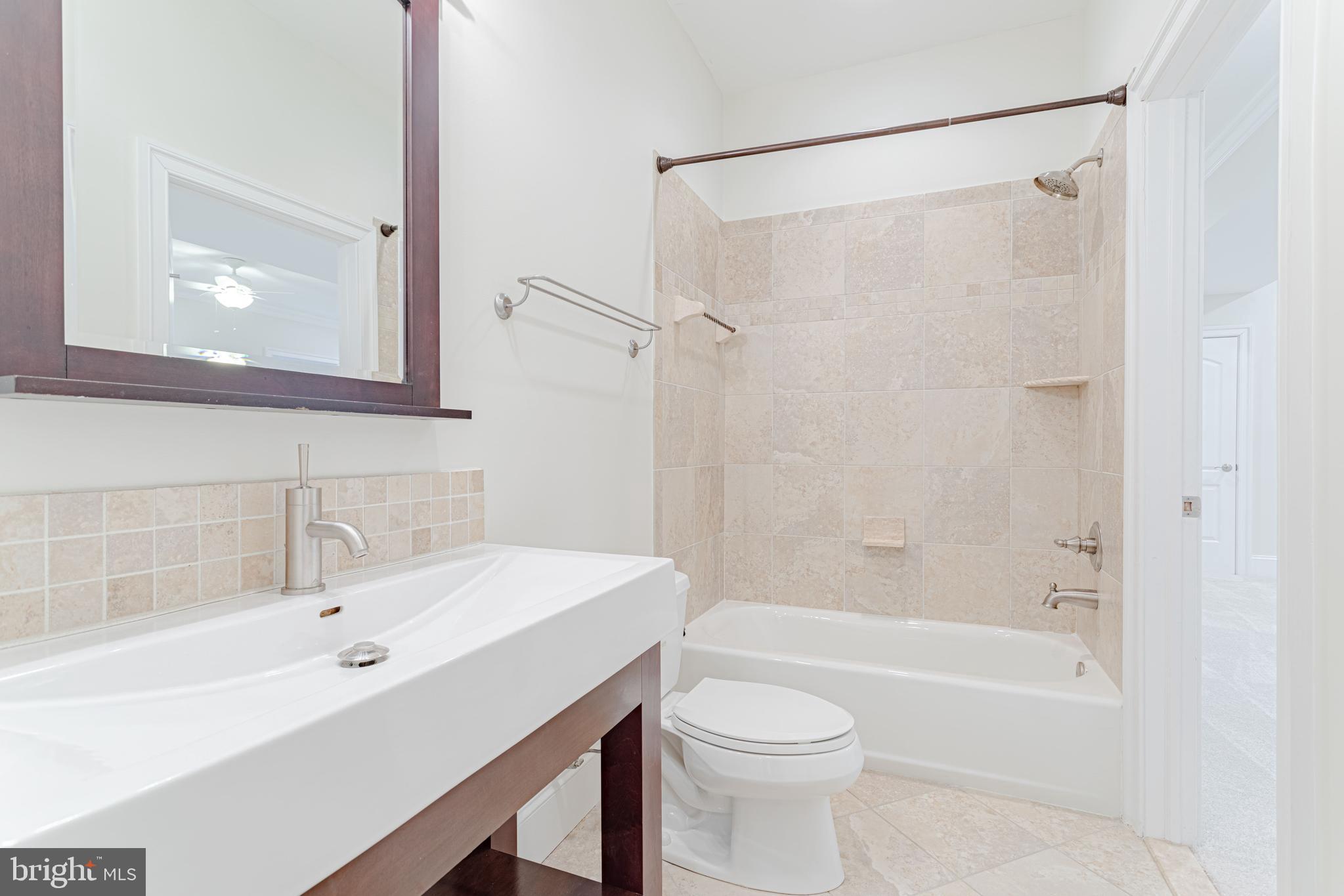 1206 Summit Road McLean, VA 22101 - Photo 42 of 45 a bathroom with a bathtub shower sink vanity and toilet