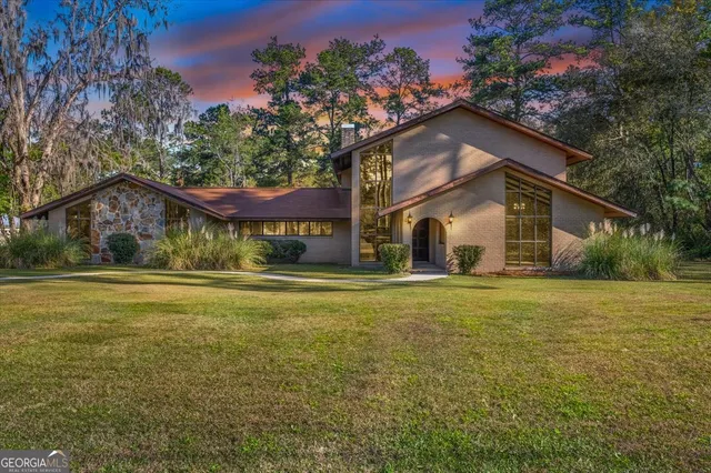 a view of outdoor space with garden and trees