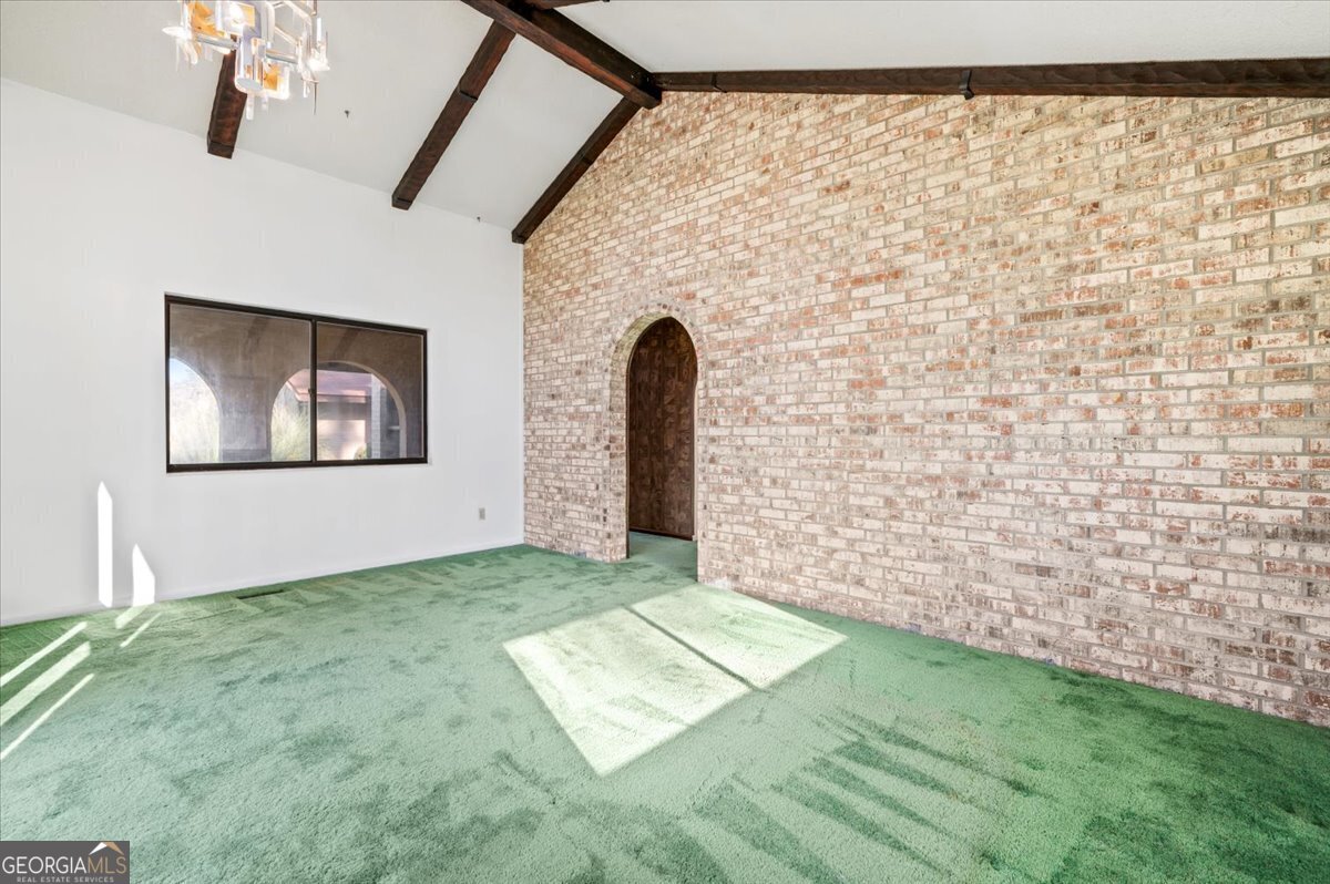 2066 Cherokee Street Waycross, GA 31503 - Photo 11 of 56 a view of a big room with wooden floor and windows