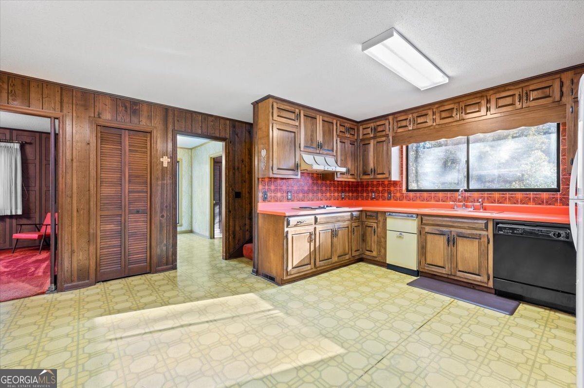 2066 Cherokee Street Waycross, GA 31503 - Photo 15 of 56 a kitchen with stainless steel appliances granite countertop a stove a sink and a microwave