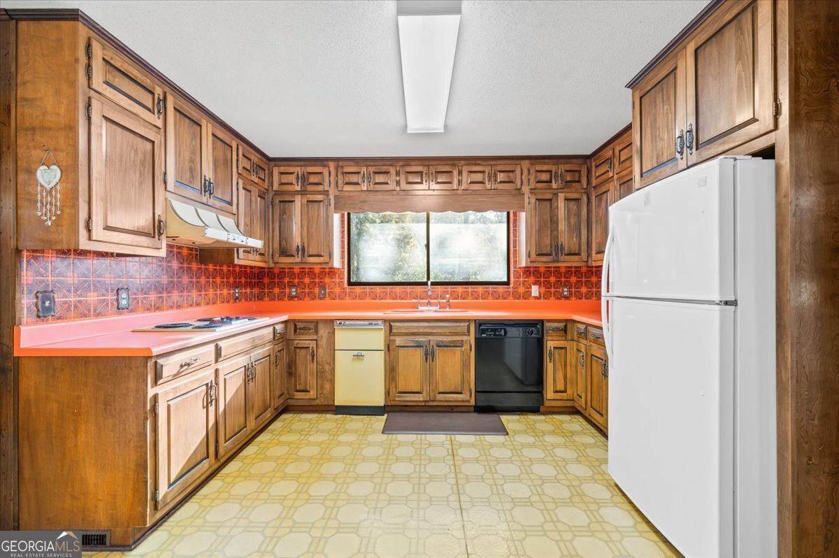 2066 Cherokee Street Waycross, GA 31503 - Photo 17 of 56 a kitchen with a refrigerator and a sink