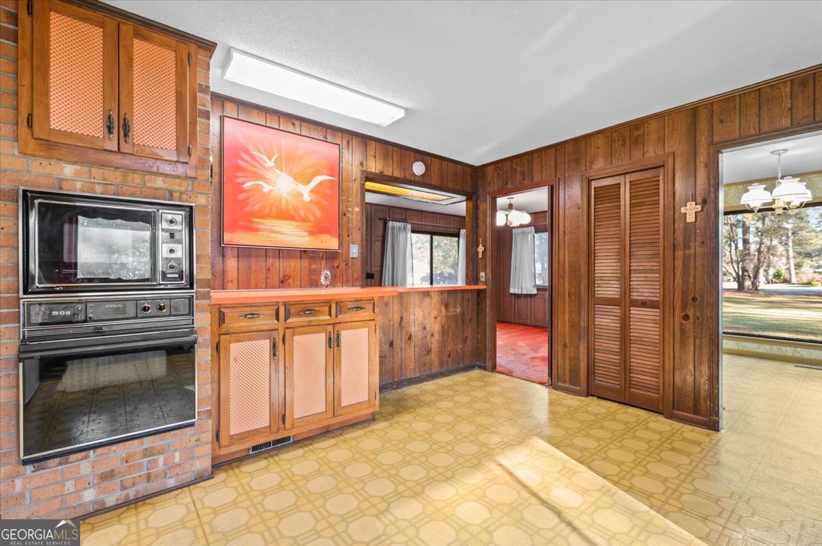 2066 Cherokee Street Waycross, GA 31503 - Photo 19 of 56 a kitchen with stainless steel appliances granite countertop a stove a sink and a microwave