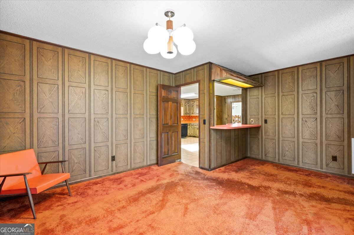 2066 Cherokee Street Waycross, GA 31503 - Photo 24 of 56 a bedroom with a bed and a chandelier