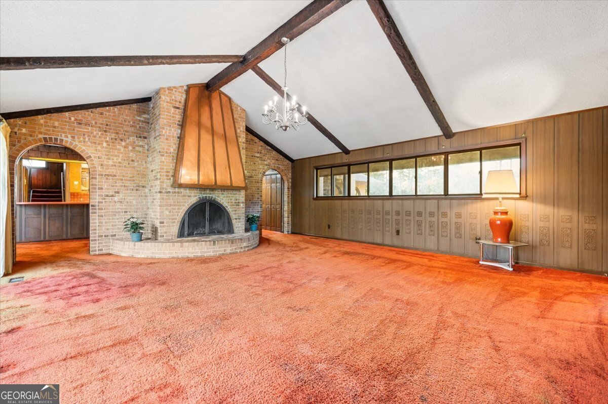 2066 Cherokee Street Waycross, GA 31503 - Photo 29 of 56 a view of an empty room with a fireplace and a window