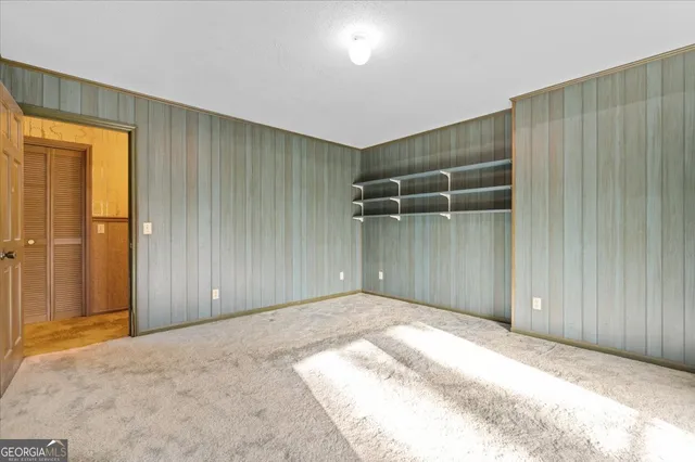 an empty room with closet and a bathroom