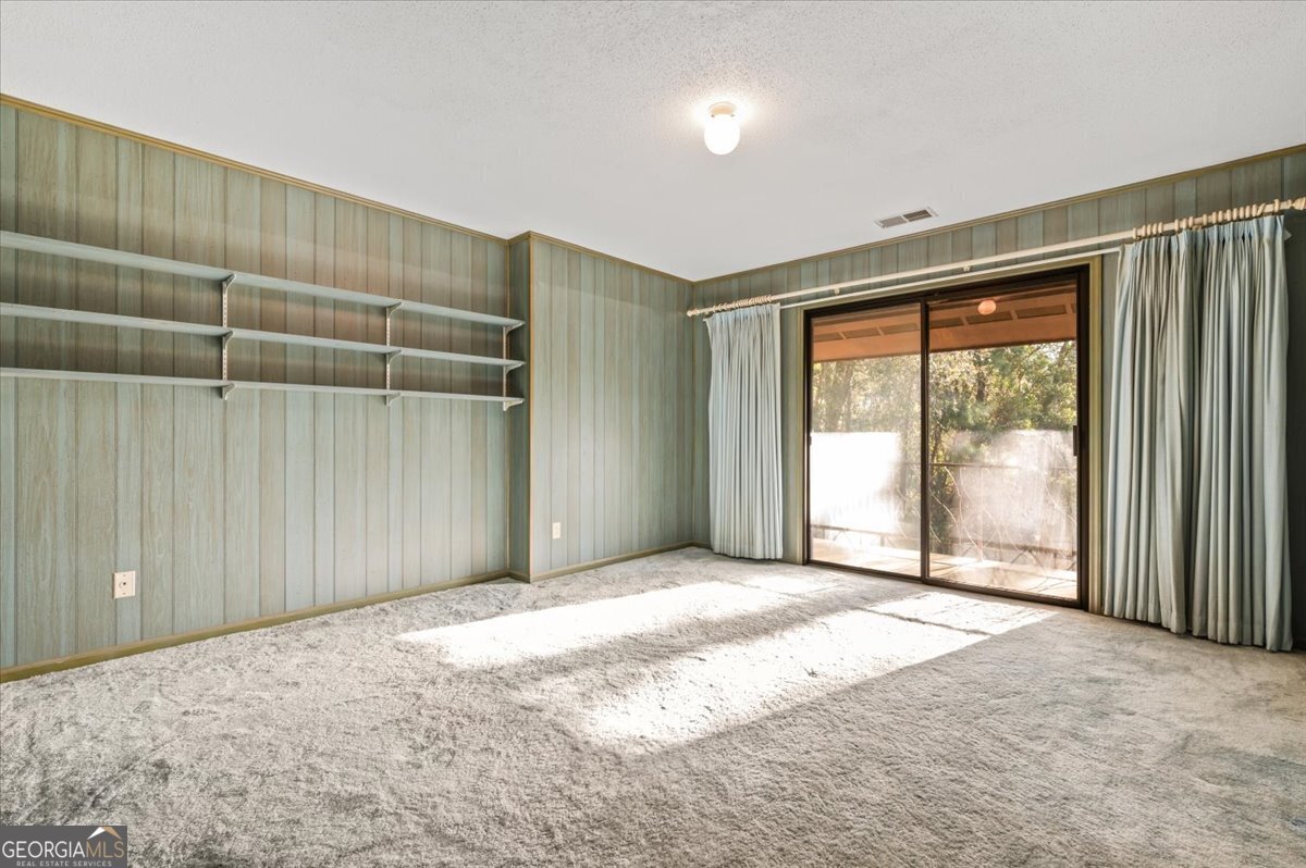 2066 Cherokee Street Waycross, GA 31503 - Photo 39 of 56 a view of an empty room with wooden floor and a window