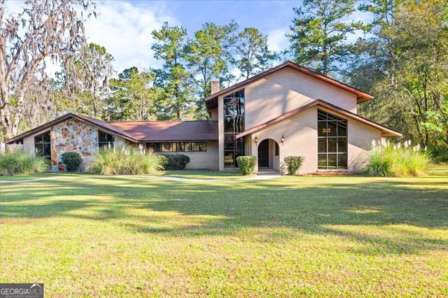 a house view with swimming pool in front of it
