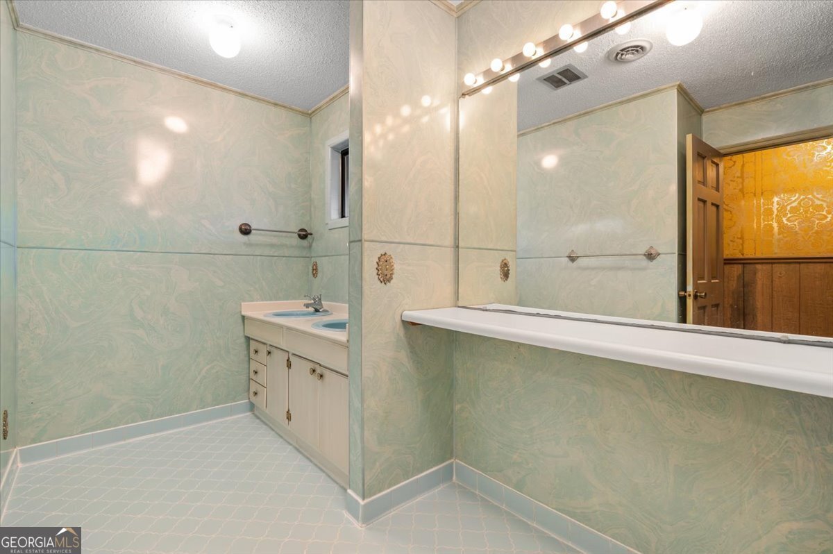 2066 Cherokee Street Waycross, GA 31503 - Photo 41 of 56 a bathroom with a double vanity sink a mirror and a shower