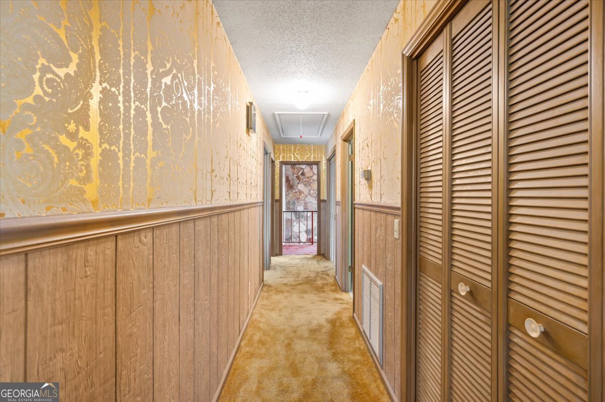 2066 Cherokee Street Waycross, GA 31503 - Photo 42 of 56 a view of a hallway with wooden floor and a bathroom