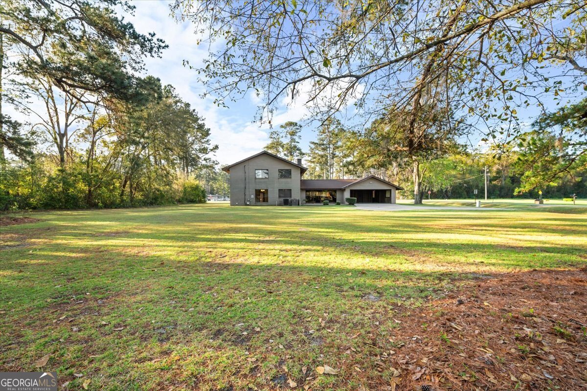 2066 Cherokee Street Waycross, GA 31503 - Photo 49 of 56 a view of a house with a large trees