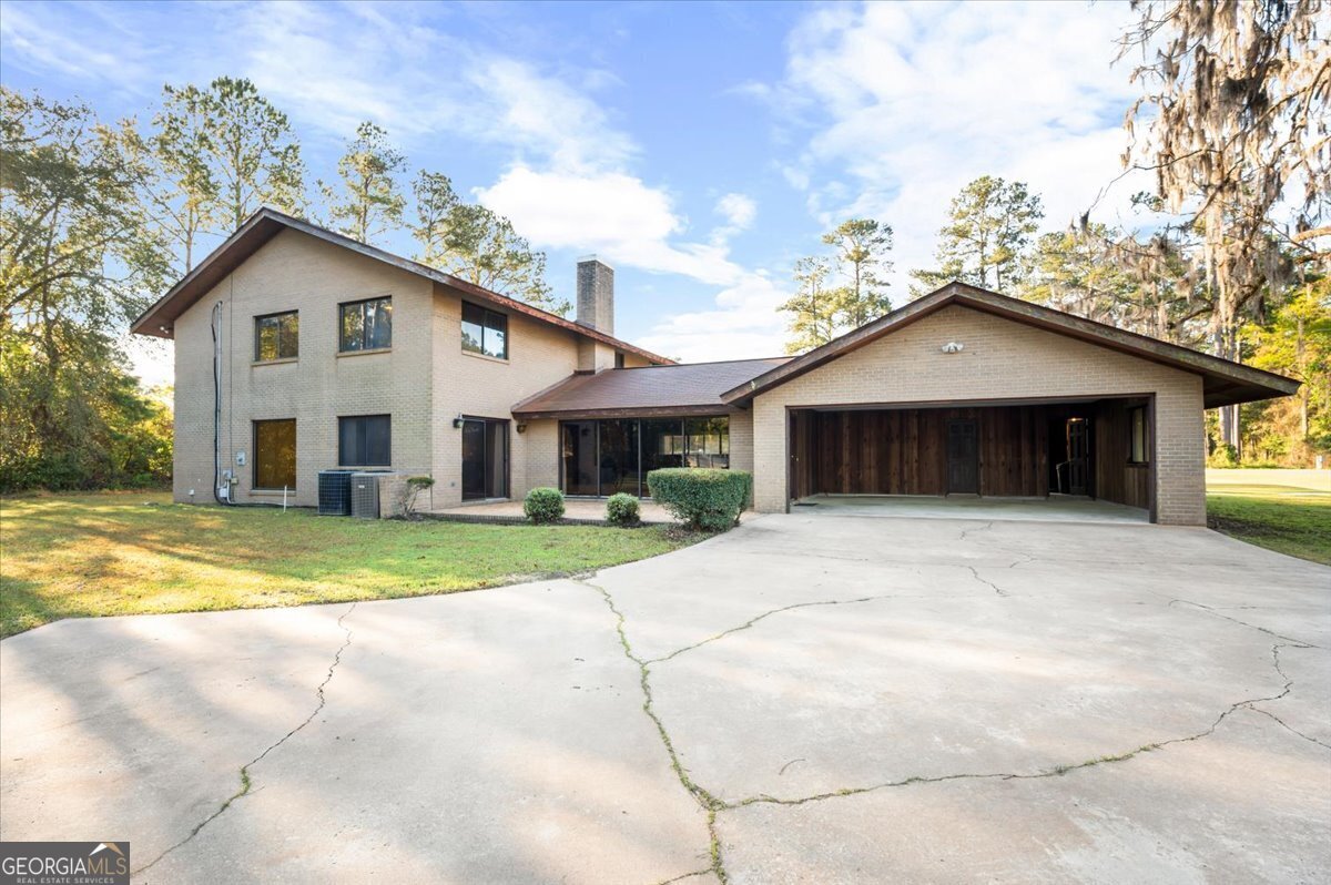 2066 Cherokee Street Waycross, GA 31503 - Photo 50 of 56 a view of a house with a yard and large tree