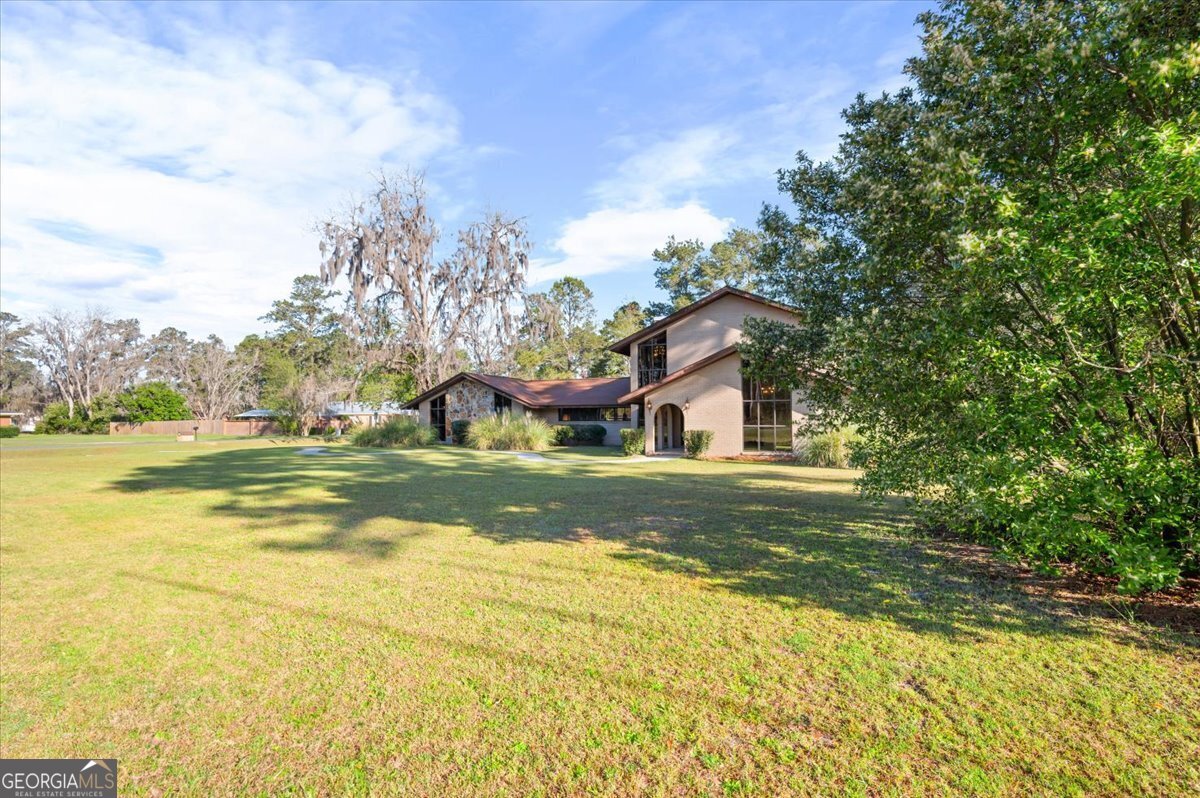 2066 Cherokee Street Waycross, GA 31503 - Photo 51 of 56 a front view of house with yard and green space