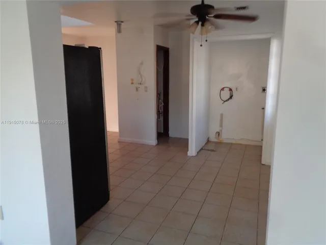 a kitchen with a refrigerator and a sink