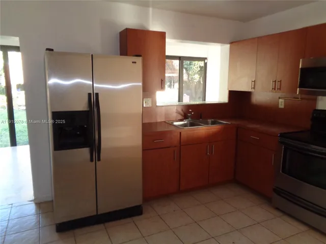 a kitchen with a window a sink and a cabinets