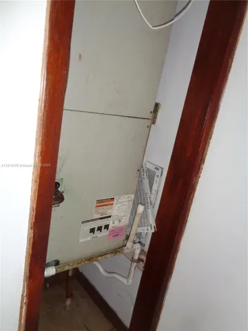 a view of a hallway with wooden walls and entryway