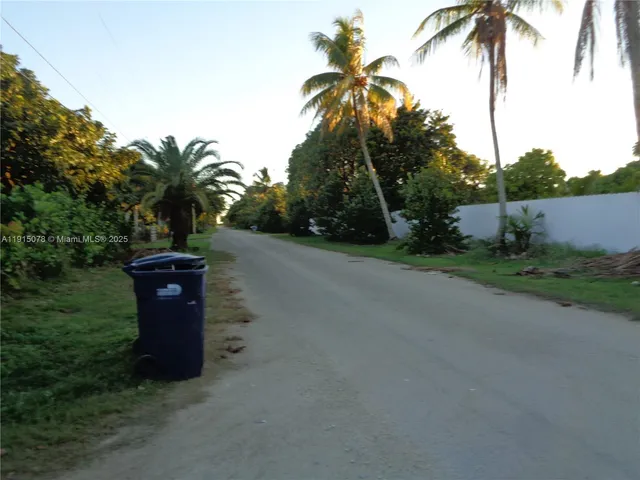 a view of a field with trees in the background